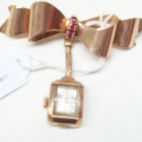 14ct rose gold bow brooch set with garnets & suspended watch (Ebel) TW 177 grms - Sold for $195 - 2012