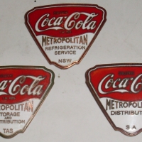 3 x vintage enamel COCA-COLA Metropolitan Storage & Distribution  badges, marked Tas, SA, NSW made by Swann & Hudson, Melbourne - Sold for $61 - 2012