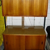 1970/80's Teak Veneer and laminex small wall unit, fold out top section and sliding doors to lower with black metal frame - Sold for $61 - 2012