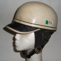 Vintage Italian motorcycle helmet with black peak and leather neck protector - AGV label to side - Sold for $55 - 2012