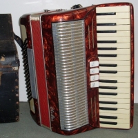 1950's ELETTRA Piano Accordion, with red marbleized body with carry case - Sold for $183 - 2012