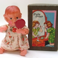 2 x vintage Japanese celluloid clock work toys - boxed Modern Toys Pretty Peggy holding mirror & powder puff & crawling baby wearing red spotted rompe - Sold for $61 - 2012