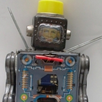 Vintage Japanese boperated tin ROBOT - grey body, yellow top, face showing in helmet af - Sold for $61 - 2012