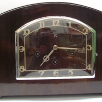 Circa 1930's wooden cased mantle clock - west minister chime, stylish deco shape, marked with crossed arrow emblem - Sold for $159 - 2012