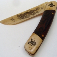 Vintage carved bone oriental letter opener with engraved traditional designs and characters, fold up pocket knife like - Sold for $55 - 2012