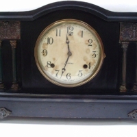 SESSIONS MANTLE CLOCK in wooden case with curved top & brass legs and decorations, original label to bottom, (pendulum weight at front desk) - Sold for $146 - 2013