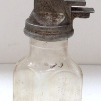 GARGOYLE  MOBIL 1qrt oil bottle with embossed text FILPRUF to diamond shape bottle Gargoyle emblem to cast metal top - Sold for $293 - 2013