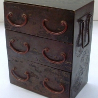 Miniature metal oriental chest with engraved traditional landscape design to 3x drawers & floral cameos to side - Sold for $152 - 2013