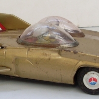 1950's JAPANESE TIN TOY CAR futuristic design in gold colour with fins to back, friction drive - Sold for $110 - 2013