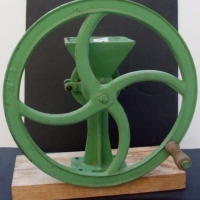 Cast iron coffee grinder re-painted light green, set to wooden base and marked H-1 to body, 44cm H - Sold for $73 - 2013