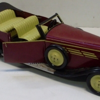 1930's Large pressed tin wind-up Art Deco roadster painted  maroon cream and black SAYA Brand - Sold for $61 - 2013