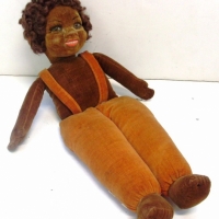 1920/30's 'Norah Welling's black doll - glass eyes, mohair wig, pearl buttons to orange trousers and suspenders - 38cm (H) - Sold for $98 - 2013