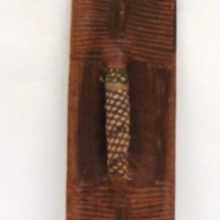 Carved wooden Tribal Hardwood shield with material wrapped around the handle and incised decoration 62 cm long - Sold for $159 - 2013