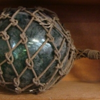 Large Fishing float green glass with rope surround - Sold for $61 - 2013