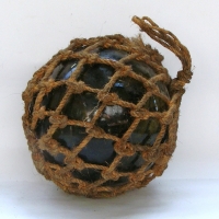 Large glass fishing float in rope net - Sold for $55 - 2013