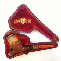 Boxed acorn and oak leaf patterned Meerschaum pipe with silver fittings and amber mouthpiece - Sold for $134 2014