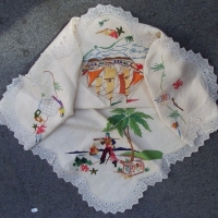 1930's Linen supper cloth with lace trim Colourful embroidered image of PIRATE with sailing ship, treasure chest & parrot Approx 90cm x 90cm - Sold for $55 - 2014