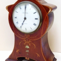 Art Nouveau wooden mantle clock made in France for Thos Webb & Sons, Melbourne - waisted shaped with inlaid woods & mop - 24cms H - Sold for $281 - 2014