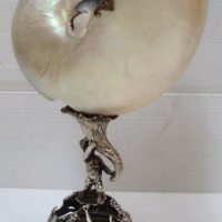 Sterling Silver mounted Nautilus shell hallmarked for London 1981 with Three images of Poseidon and his trident holing up a cherub supporting  - Sold for $116 - 2014