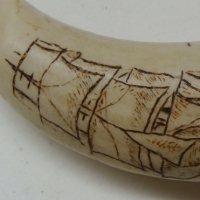 Sperm whales tooth with scrimshawed design of a boat under sail with the initial KEK - Sold for $79