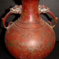 Japanese bronze vase with a wood look finish and animal head handles - Sold for $73 - 2014