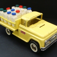 BUDDY  L tin toy Milk truck with all original plastic milk containers - painted yellow, GC - Sold for $98 2014