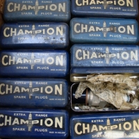 Boxed set of Champion extra range spark plugs in original tins - Sold for $415 2014