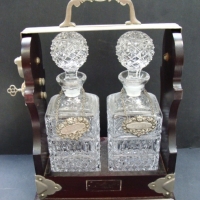 Victorian wooden lockable Tantalus with two crystal decanters - Sold for $195 2014