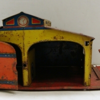 Lithographed tin plate toy garage with hoist and decal of petrol bowser and motorcycle marked made in Japan - Sold for $61 2014