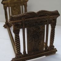 c1900 brass adjustable book stand with ornate classical image to ends - Sold for $43