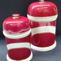 Pair Victorian porcelain apothecary jars with maroon glaze and unusual domed lids - Sold for $61 2014