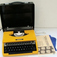 Retro bright yellow and black Silverette portable typewriter with original paperwork - Sold for $24 - 2014
