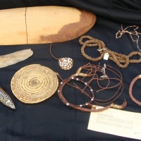 Coolamon with aboriginal jewellery made from ochre, seed casings, grass, pandanus etc , stone knife painted clap stick etc all collected circa 1981 in - Sold for $67 - 2014