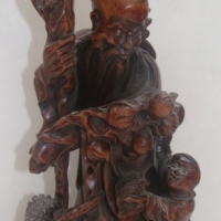 Vintage heavily carved Eastern wooden figure - The immortal - bearded man with staff holding pomegranite - Sold for $122 - 2014