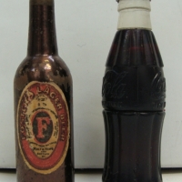 2 x small vintage novelty bottle shaped lighters - Coca Cola and Fosters Larger - Sold for $67 - 2014