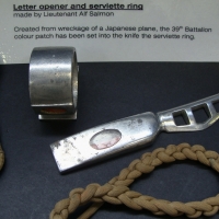 Group lot - Trench art letter opener and napkin ring made from the aluminum wreckage of a Japanese plane inset with 39th battalion colour patch and of - Sold for $85 - 2014