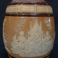 Lidded stoneware jar by Doulton Lambeth with applied cherubs and people of the Commonwealth illustrated around the barrel circa 1887 celebrating the G - Sold for $24 - 2014