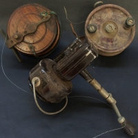 Group of fishing reels including bakelite Ebro and a cedar and brass reel - Sold for $30 - 2014