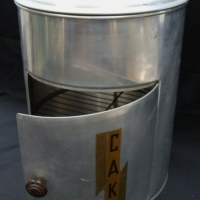 1930's Aluminum cake canister with unusual door and interior frame - Sold for $30 - 2014