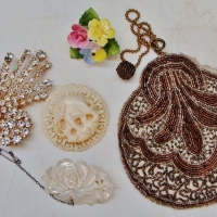 Group lot incl Pretty 1910 small beaded evening purse, carved mother-of-pearl floral brooch, carved bone elephant brooch, Cara China floral brooch & l - Sold for $67 - 2014