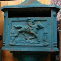 Cast iron letterbox with horse racing scene & two pieces of cast iron trellis - Sold for $73 - 2014