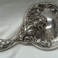c1910 Art Nouveau silver plated hand mirror - heavily embossed with flowers & ladies head - beveled mirror - Sold for $30 - 2015