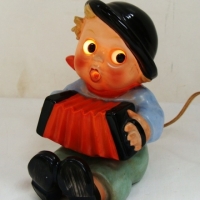 Fab 1950's Goebels Hummel style novelty perfume lamp - boy playing an accordion, eyes light up - 14cms H - Sold for $171 - 2015