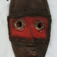 Papuan mask with bush string beard  and coloured cloth decoration - Sold for $55 - 2015