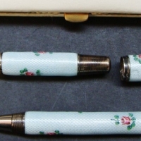 1920's Ladies fountain pen & pencil set with 14kt gold nib, European silver marked 935 decorated with light blue Gillousche enamel and roses in white  - Sold for $110 - 2015