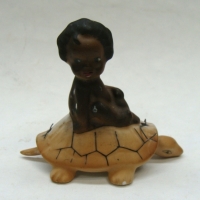 Vintage BROWNIE DOWNING porcelain figurine - girl on a turtle with attached turtle head and tail - 7cm H - Sold for $27 - 2015