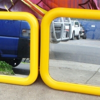 2 x retro bright yellow plastic tubular framed wall mirrors - various sizes - Sold for $49