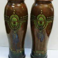 Pair vintage c 1910 art pottery vases - Green & brown majolica glaze with inclised symetrical decoration to top - no marks sighted, one with damage -  - Sold for $159 - 2015