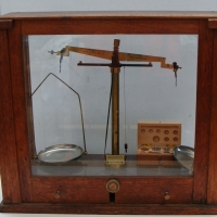 2 x items incl 1930's glass & wood cased laboratory brass balance scale on a brown Bakelite base - manufactured by Griffin & Tatlock Ltd Approx 42cm H - Sold for $220 - 2015