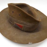 (a) Vintage WWII Australian military part uniform - jacket plus slouch hat with original blue and red regimental patch to hat band and 3 x Australia badge - Sold for $427 - 2015